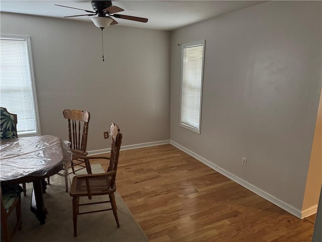 dining area with ceiling fan, hardwood / wood-style flooring, and a healthy amount of sunlight