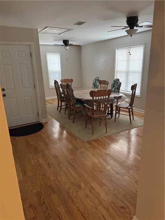 dining room featuring hardwood / wood-style flooring, ceiling fan, and a healthy amount of sunlight