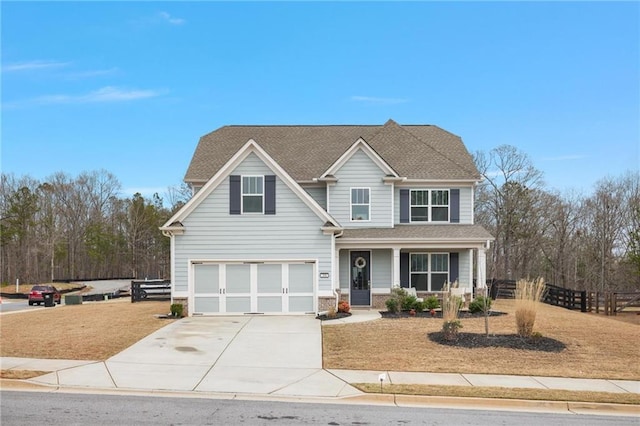 view of front of home featuring concrete driveway, a front yard, an attached garage, and fence