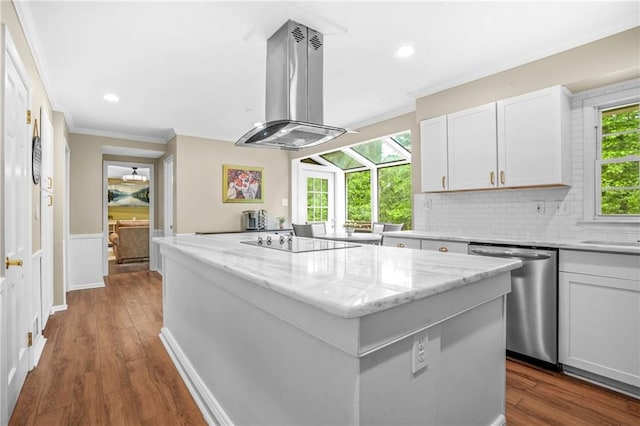 kitchen featuring dishwasher, crown molding, island range hood, a kitchen island, and black electric stovetop