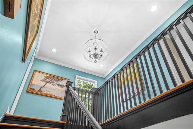 staircase featuring ornamental molding, an inviting chandelier, and recessed lighting