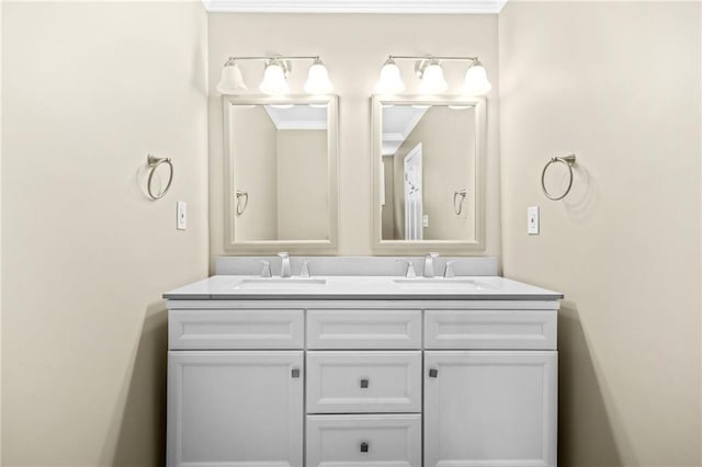 bathroom featuring double vanity, crown molding, and a sink