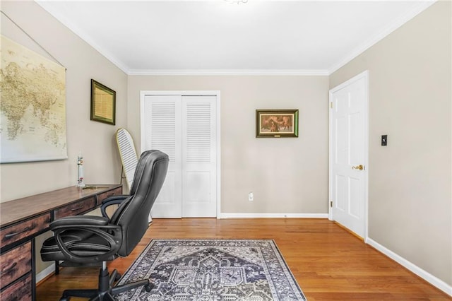 office space featuring ornamental molding, baseboards, and wood finished floors