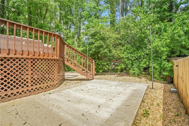 exterior space featuring a deck, stairway, and fence
