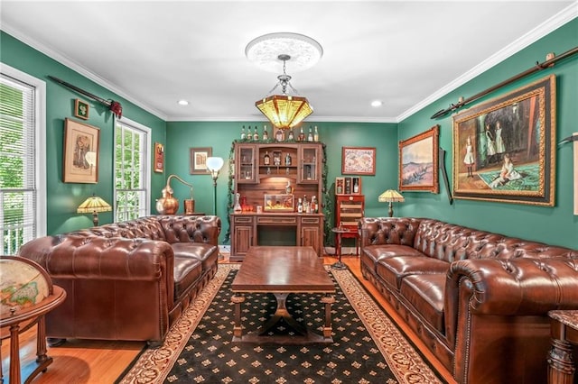 living area featuring wood finished floors, ornamental molding, and recessed lighting