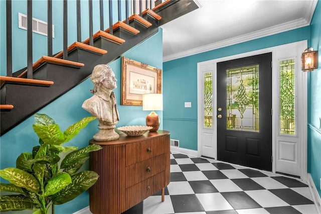 foyer entrance with ornamental molding, visible vents, tile patterned floors, stairway, and baseboards