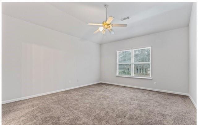 spare room with baseboards, visible vents, a ceiling fan, and light colored carpet