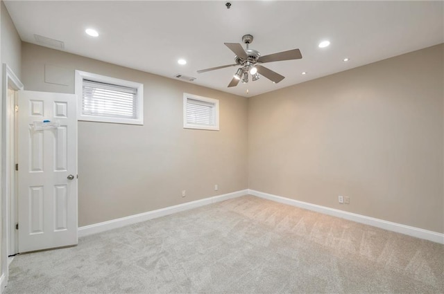 empty room with baseboards, recessed lighting, a ceiling fan, and light colored carpet