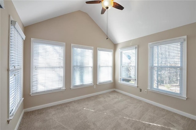 unfurnished room with a ceiling fan, carpet floors, baseboards, and vaulted ceiling