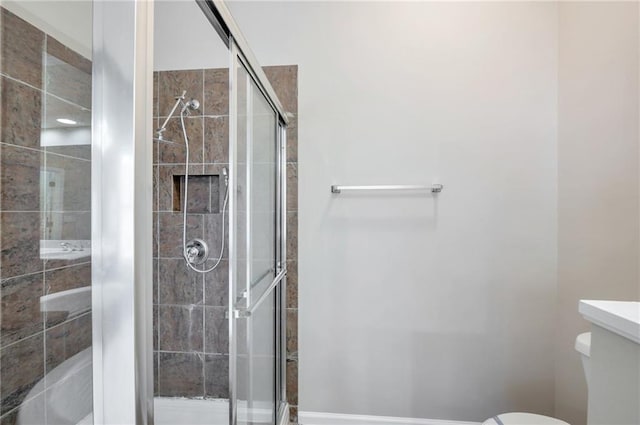 bathroom with toilet and a stall shower