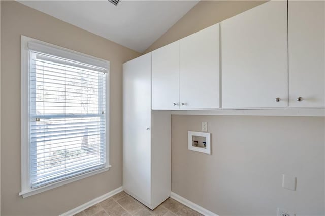 laundry area featuring washer hookup, cabinet space, and baseboards