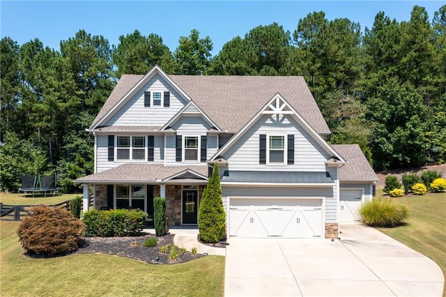 176 Red Wood Dr, Dallas, GA 30132 - craftsman inspired home featuring concrete driveway, stone siding, a front yard, and a trampoline