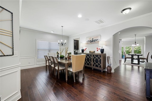 176 Red Wood Dr, Dallas, GA 30132 - dining area with an inviting chandelier, crown molding, visible vents, dark wood-style floors, and arched walkways
