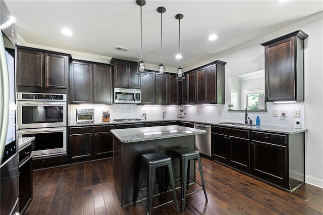 176 Red Wood Dr, Dallas, GA 30132 - kitchen with backsplash, a kitchen island, visible vents, appliances with stainless steel finishes, and a sink