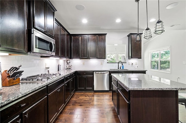176 Red Wood Dr, Dallas, GA 30132 - kitchen with light stone counters, a sink, stainless steel appliances, decorative backsplash, and dark wood-style floors