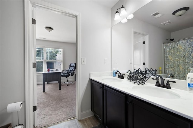 176 Red Wood Dr, Dallas, GA 30132 - bathroom with a sink, wood finished floors, double vanity, and visible vents