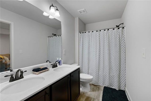 176 Red Wood Dr, Dallas, GA 30132 - bathroom featuring double vanity, toilet, visible vents, and a sink