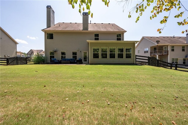 176 Red Wood Dr, Dallas, GA 30132 - rear view of house with a fenced backyard, a chimney, a lawn, and outdoor lounge area
