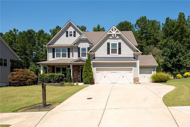 176 Red Wood Dr, Dallas, GA 30132 - craftsman house featuring an attached garage, concrete driveway, a front yard, and stone siding