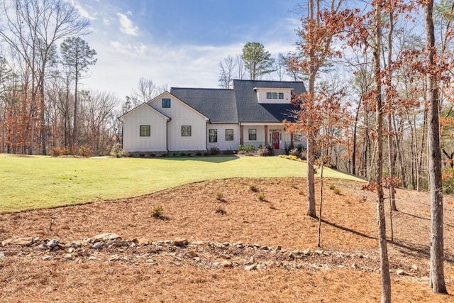 view of front of property featuring board and batten siding, roof with shingles, and a front lawn