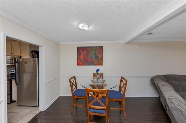 dining room featuring crown molding, hardwood / wood-style flooring, and a textured ceiling