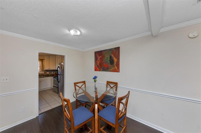 dining room with crown molding, dark wood-type flooring, and a textured ceiling