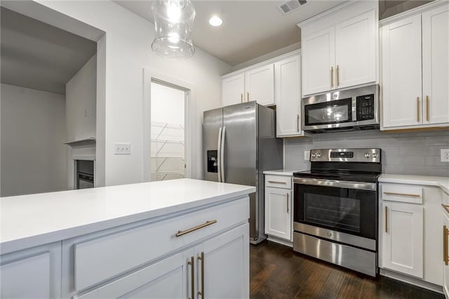 kitchen featuring visible vents, white cabinetry, appliances with stainless steel finishes, light countertops, and decorative backsplash