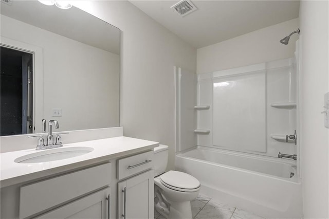 full bathroom with visible vents, toilet, marble finish floor, shower / bath combination, and vanity