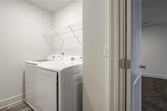 laundry room with washing machine and clothes dryer, laundry area, and baseboards