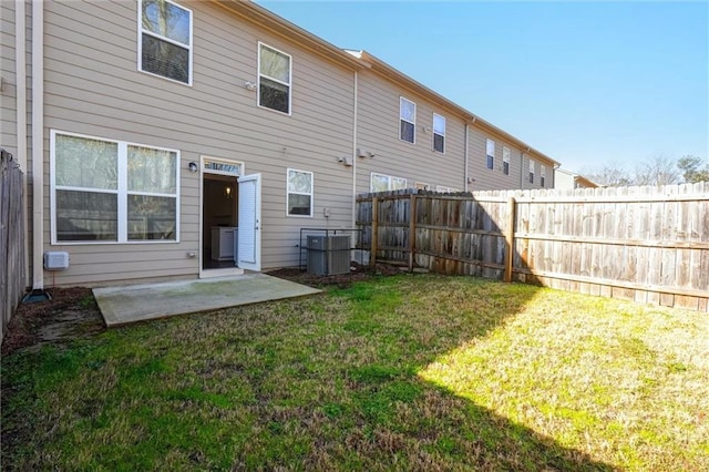 back of property with a patio area, central air condition unit, a lawn, and fence