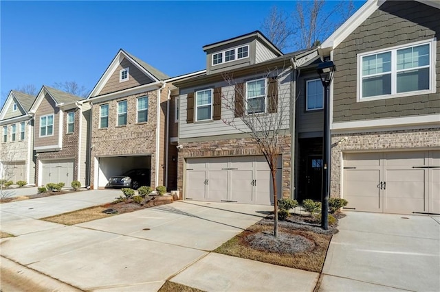 multi unit property with brick siding, concrete driveway, and a garage