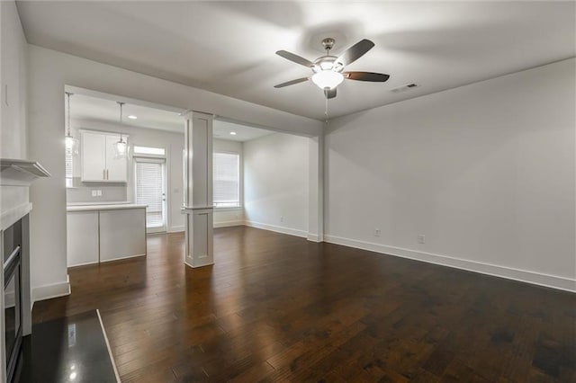 unfurnished living room featuring visible vents, baseboards, a fireplace with flush hearth, dark wood-style floors, and a ceiling fan