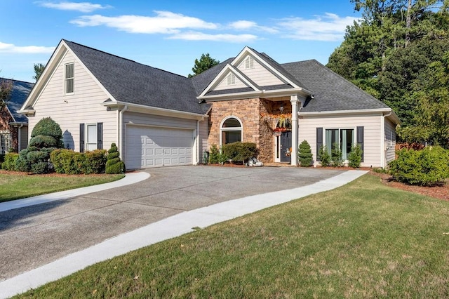 view of front of house with a front yard and a garage