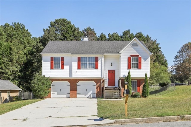 split foyer home featuring a garage and a front lawn