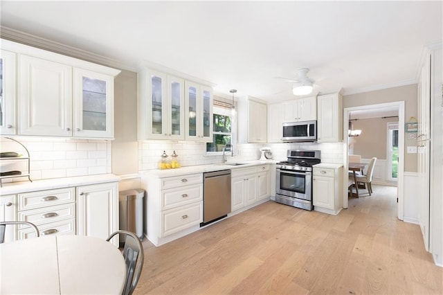 4522 Reva Ct NE, Marietta, GA 30066 - kitchen featuring appliances with stainless steel finishes, light countertops, backsplash, light wood-type flooring, and white cabinets