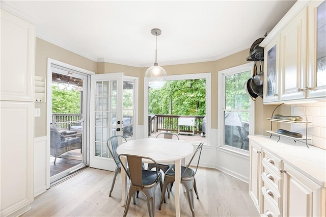 4522 Reva Ct NE, Marietta, GA 30066 - dining space featuring light wood finished floors, healthy amount of natural light, crown molding, french doors, and a wainscoted wall