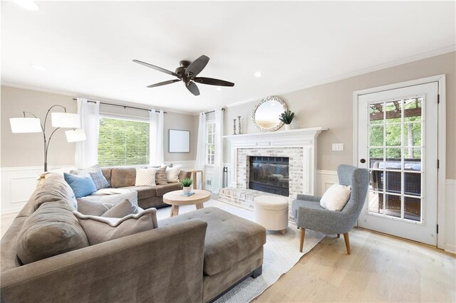 4522 Reva Ct NE, Marietta, GA 30066 - living area featuring ornamental molding, wainscoting, a decorative wall, light wood finished floors, and plenty of natural light