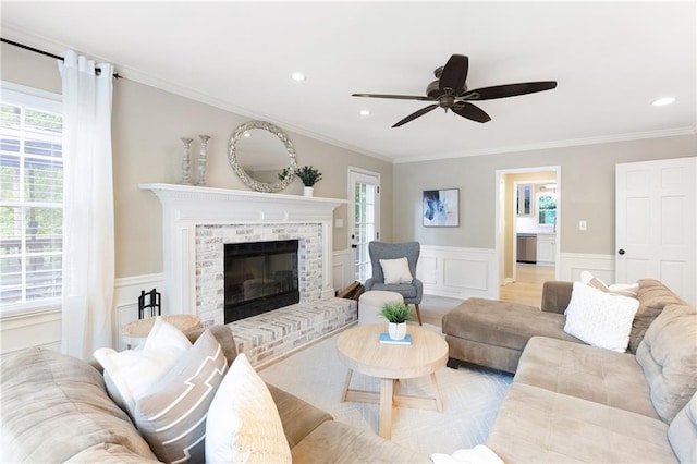 4522 Reva Ct NE, Marietta, GA 30066 - living room with ornamental molding, ceiling fan, a wainscoted wall, a brick fireplace, and a decorative wall