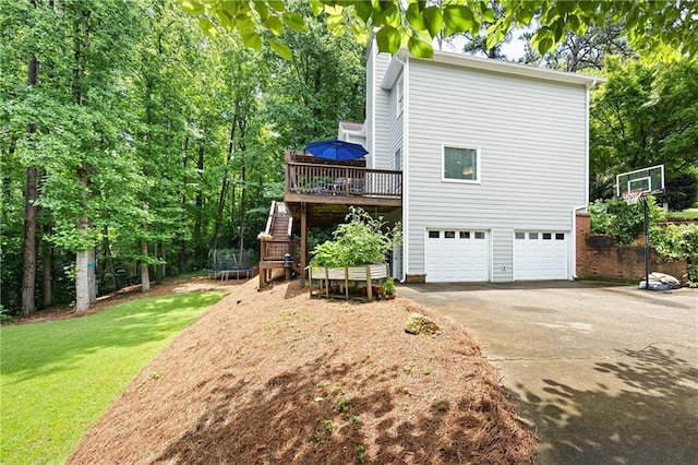 4522 Reva Ct NE, Marietta, GA 30066 - view of side of home with driveway, a wooden deck, a garage, a yard, and stairs
