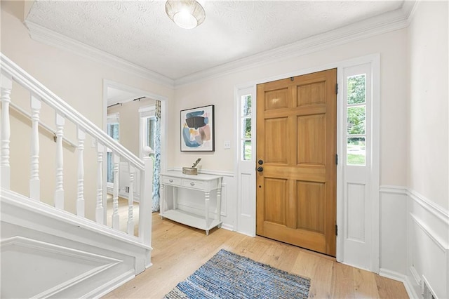 4522 Reva Ct NE, Marietta, GA 30066 - entryway with healthy amount of natural light, light wood-style floors, a wainscoted wall, a textured ceiling, and ornamental molding