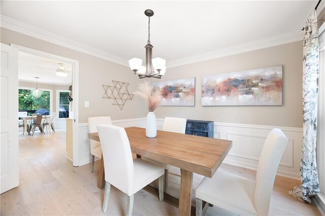 4522 Reva Ct NE, Marietta, GA 30066 - dining space featuring light wood-style floors, ornamental molding, a chandelier, and a wainscoted wall