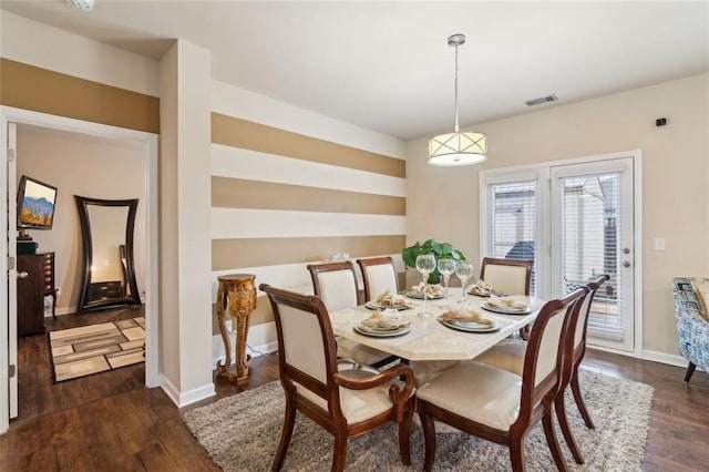 dining space featuring dark hardwood / wood-style flooring