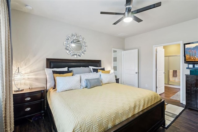 bedroom featuring dark wood-type flooring, ceiling fan, and connected bathroom