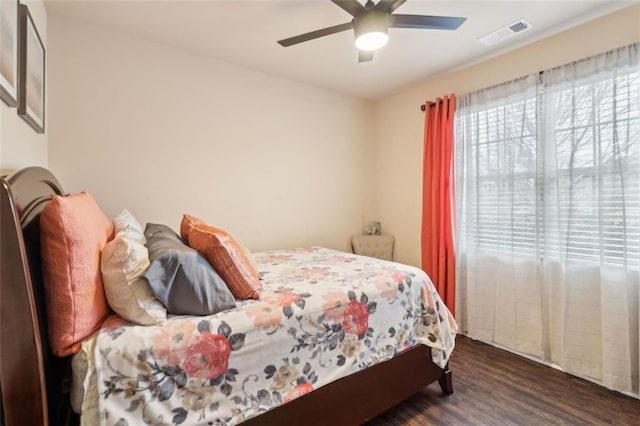 bedroom with ceiling fan and dark hardwood / wood-style flooring