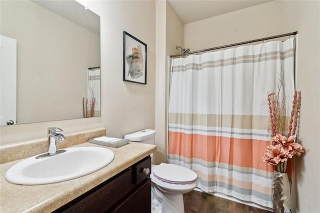 bathroom featuring hardwood / wood-style flooring, vanity, and toilet