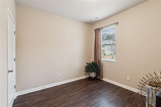 unfurnished room with dark wood-type flooring