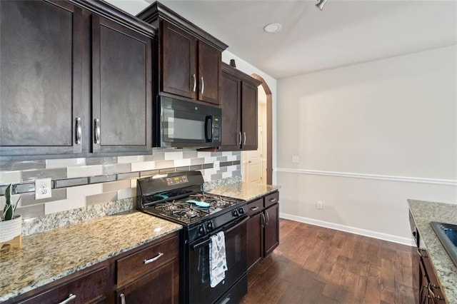 kitchen with black appliances, backsplash, dark hardwood / wood-style flooring, dark brown cabinetry, and light stone counters