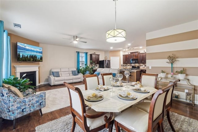 dining area featuring dark hardwood / wood-style flooring and ceiling fan