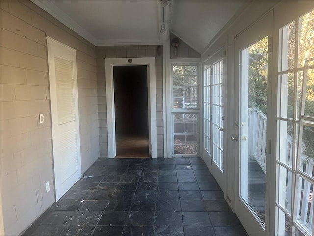 unfurnished sunroom featuring lofted ceiling