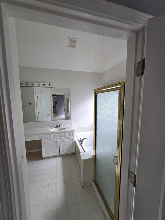 2670 Henderson Chase Ct, Tucker, GA 30084 - bathroom featuring vanity, a garden tub, tile patterned floors, a stall shower, and vaulted ceiling